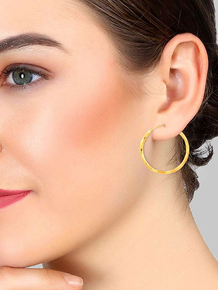 women golden hoop earring - 18534305 -  Standard Image - 2