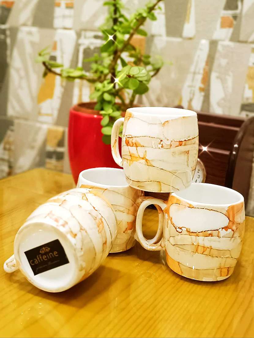 caffeine ceramic handmade yellow tea cup set (set of 4) - 19408789 -  Standard Image - 2