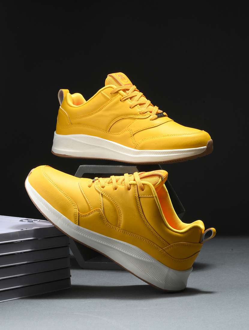 solid yellow lace-up sports shoes