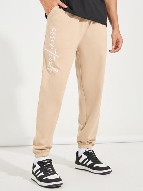 men beige placement print mid rise jogger - 21494197 - Standard Image - 0