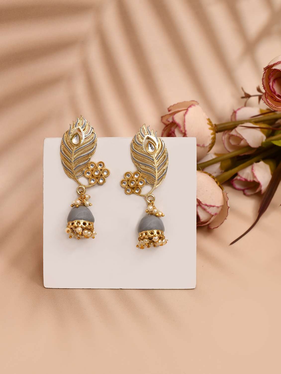 grey & gold-plated kundan stone leaf shaped jhumka earrings