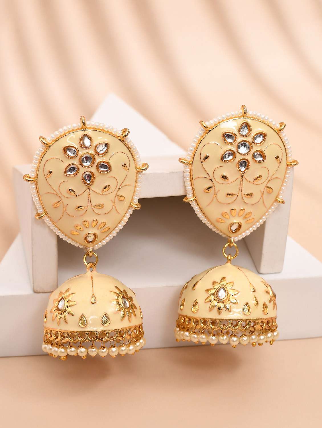cream & gold-plated dome shaped kundan stone jhumkas earrings