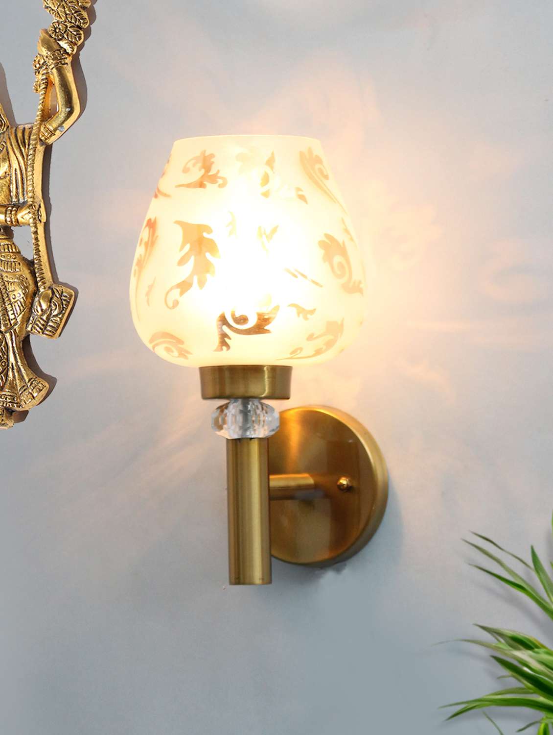 elegant golden finish wall light with floral design glass