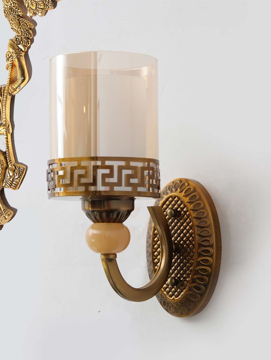 vintage brass wall sconce with decorative glass shade
