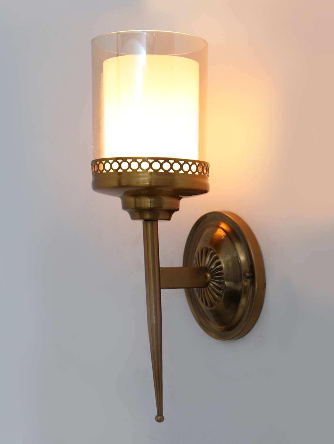 vintage brass wall sconce with decorative cutout design