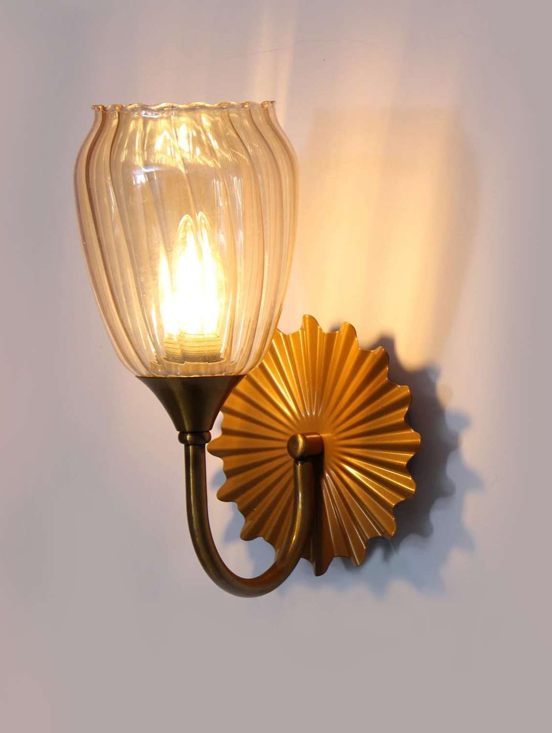 decorative brass finish fancy wall sconce with ribbed glass
