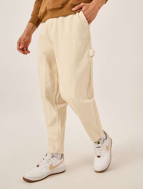 men cream solid mid rise relaxed fit jeans