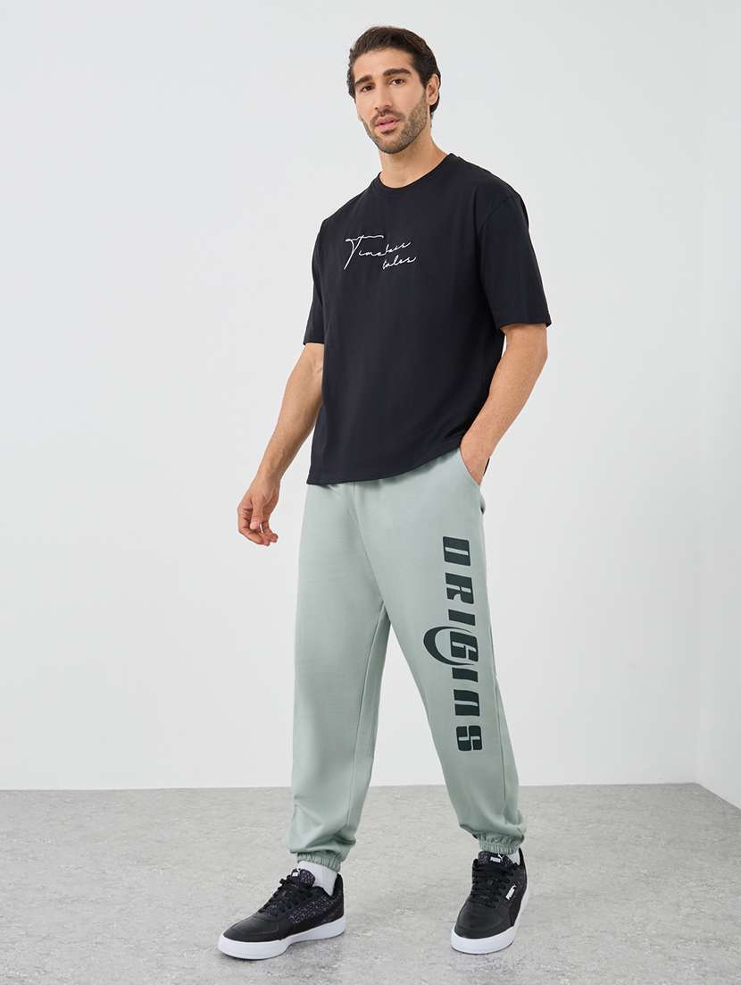 men typographic mid rise loose fit jogger - 21971631 -  Standard Image - 2