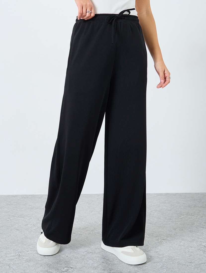 women solid high rise relaxed fit track pant
