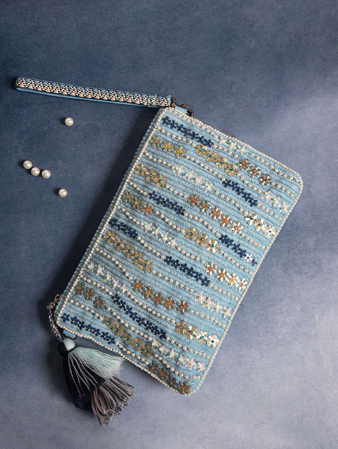 embroidered blue embellished clutch with tassels