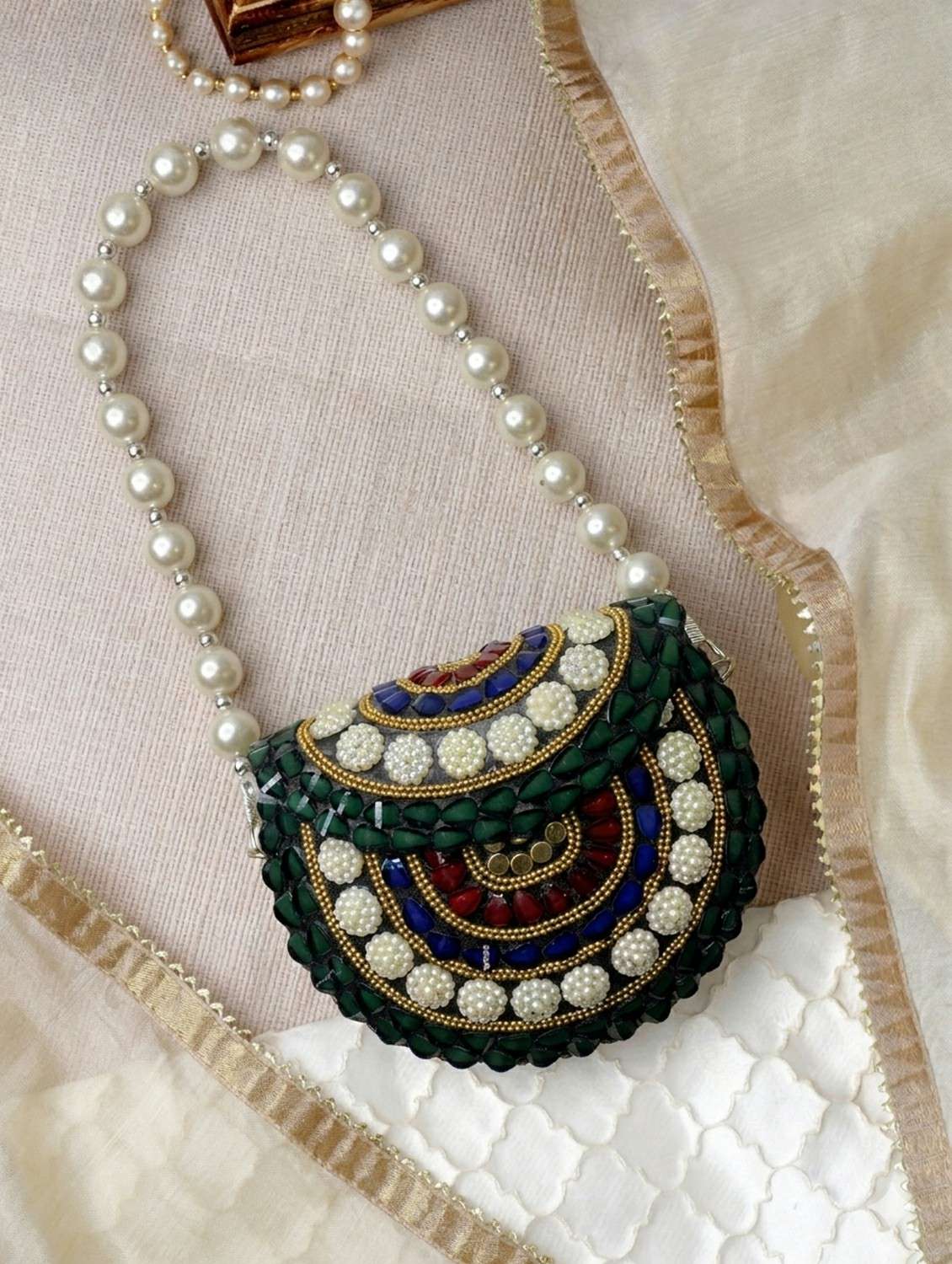 embellished green metal clutch