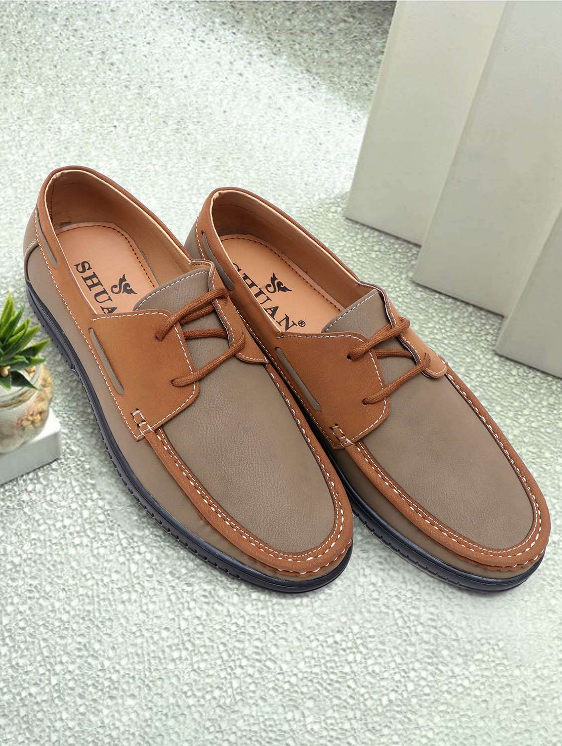 men tan slip on boatshoe