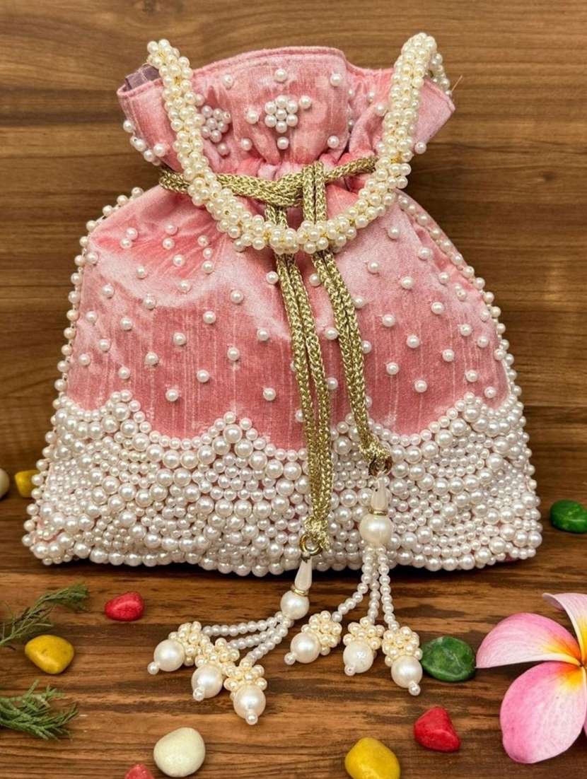 women solid with work embellished potli