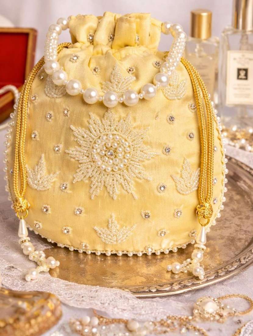 women solid with work embellished potli