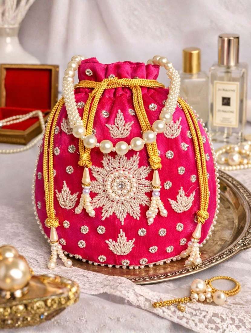 women solid with work embellished potli